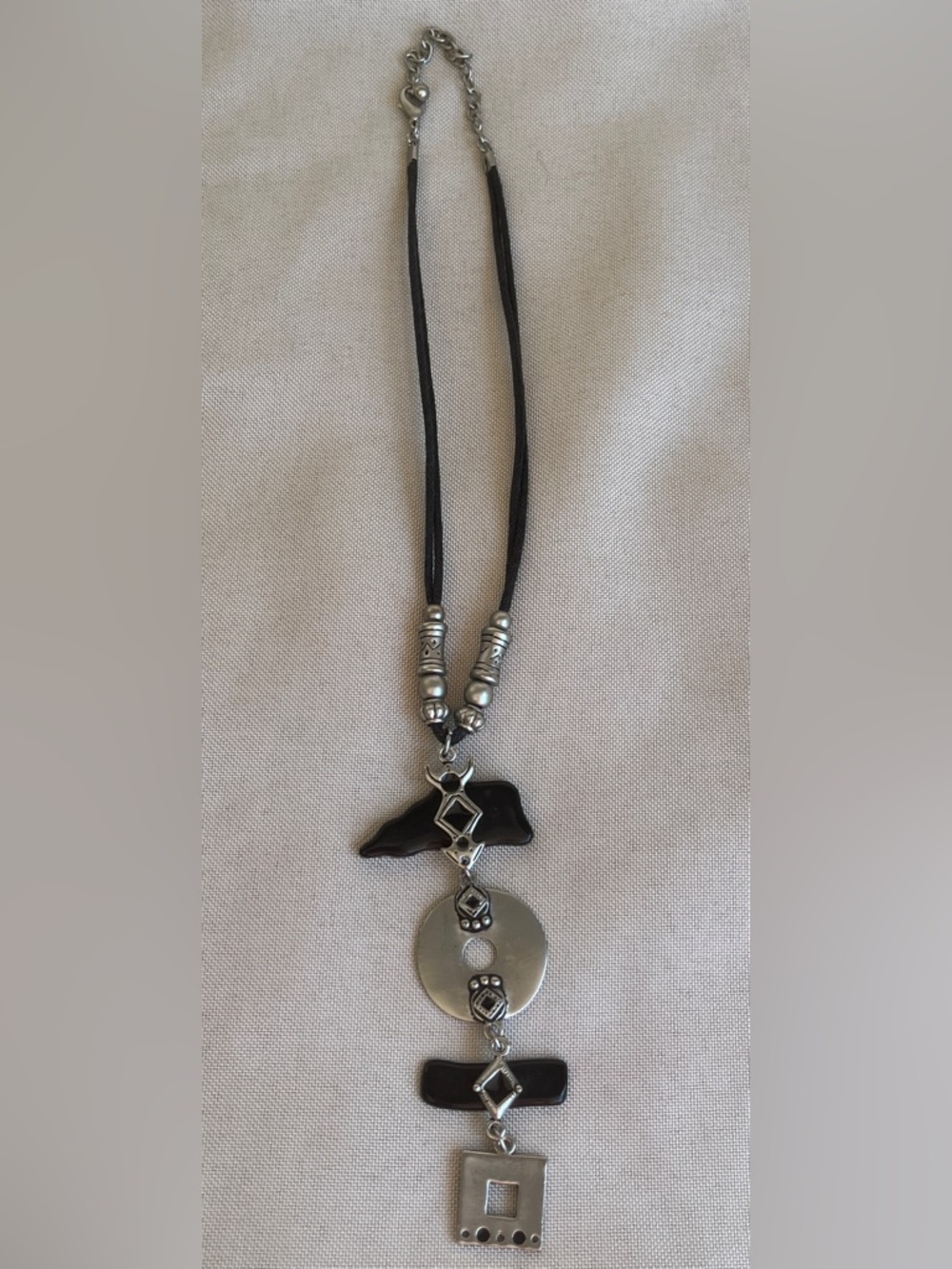 Silver tone boho statement necklace featuring black glass elements and silver